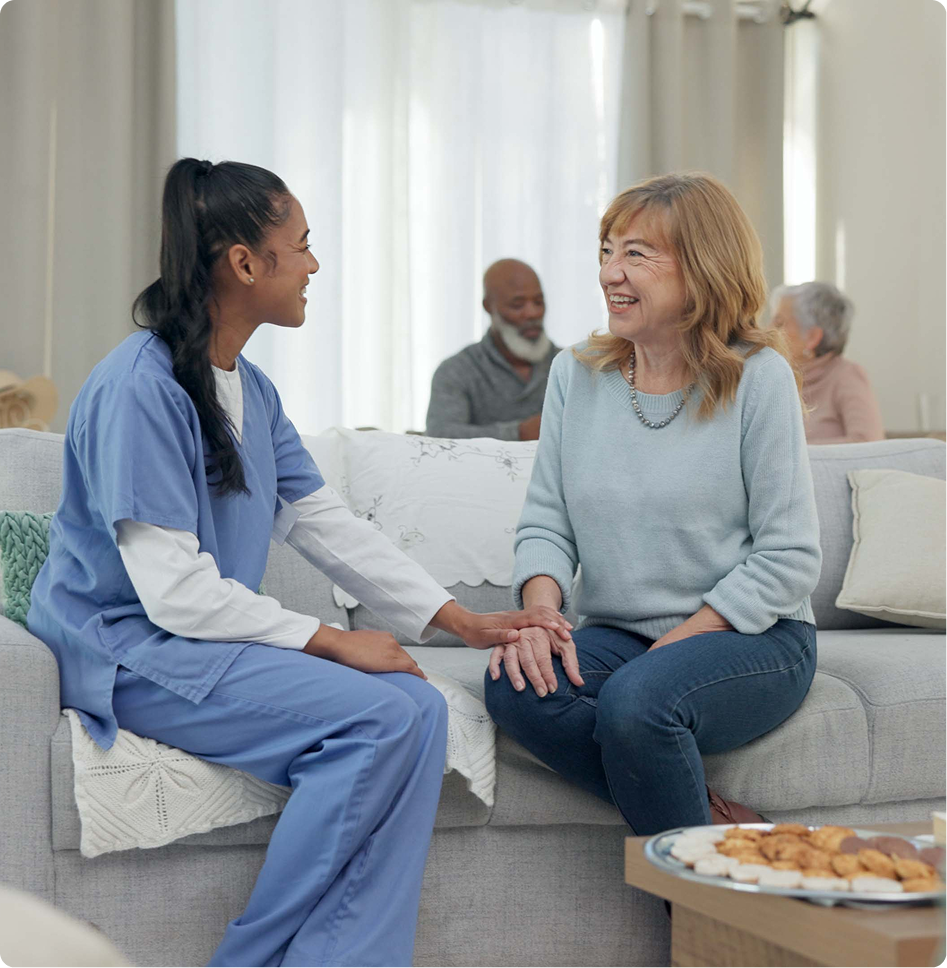 Healthcare worker talking with senior woman