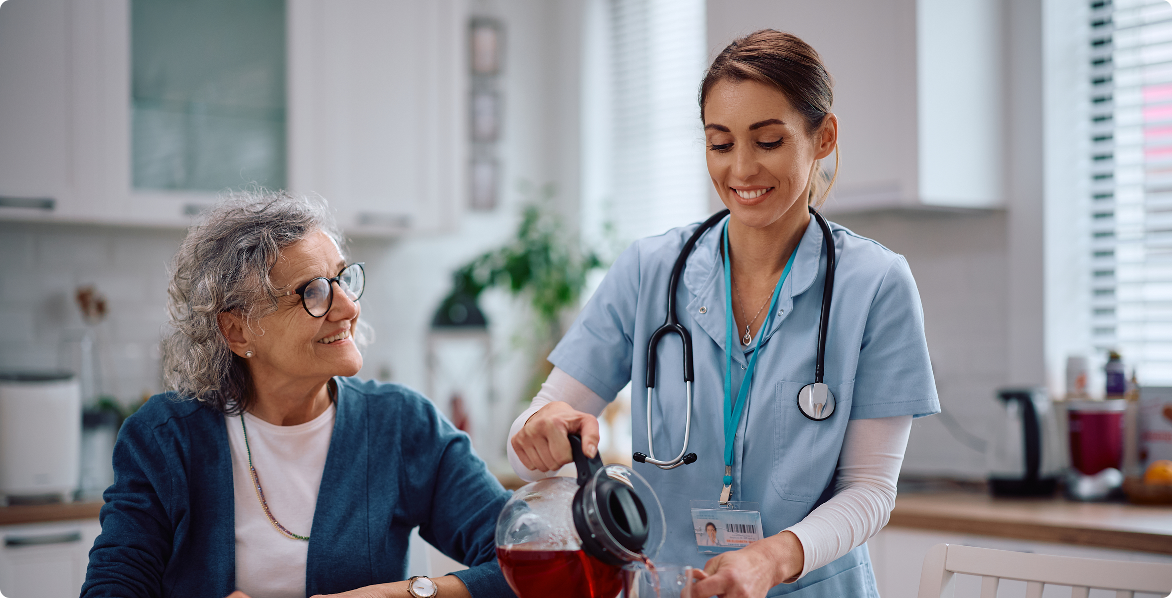 Healthcare worker assisting older adult at home